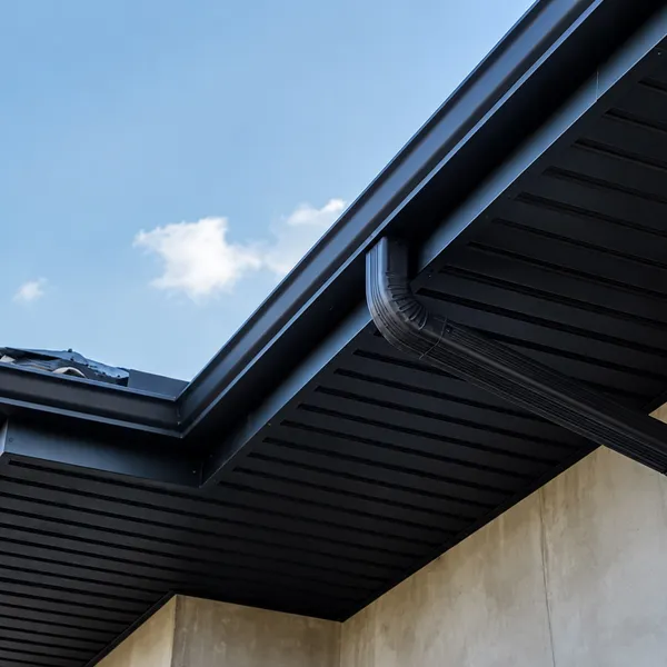 Installer working along the fascia board
